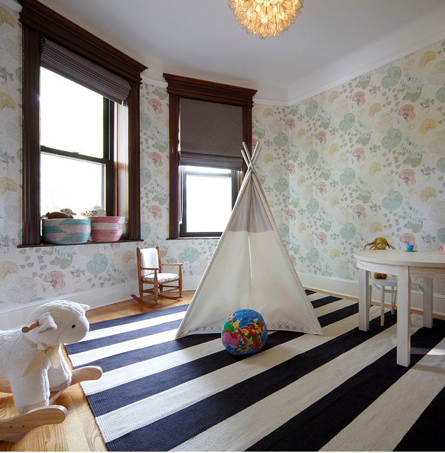 Children's room with floral wallpaper, a teepee and a striped rug