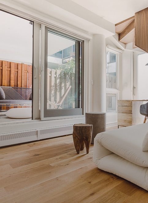 Bedroom corner with sliding glass doors opening to a terrace — West Village condo renovation