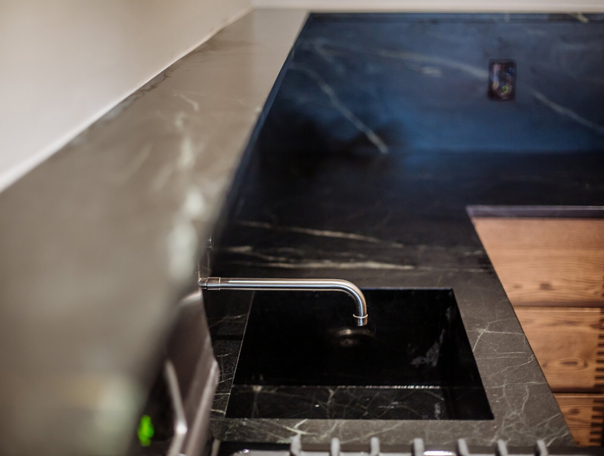 Black soapstone counter with an integrated sink — Brooklyn condo renovation
